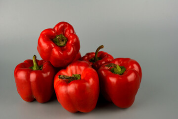 red bell pepper on gray background, food preparation process, proper nutrition
