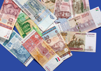 Photo of rubles bank notes from Russia, pounds bank notes, euro banknotes, dollars on blue background. Money consept