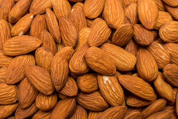 Whole almond nuts background. Vegetarian healthy snack. Organic food. Vegetable diet.