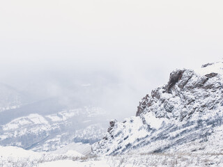Fototapeta na wymiar rock in the snow, winter background