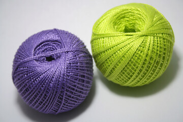 Balls of colored yarn on white background.