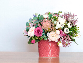 Vase with beautiful flowers bouquet of roses, lavender, eucaliptus on table against white background. Space for text