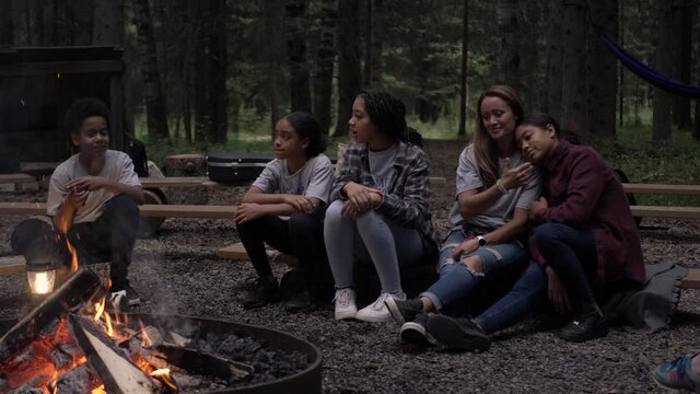 Slow Motion Of Family Sitting Around Campfire