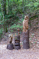totem in inlaid wood positioned in the woods