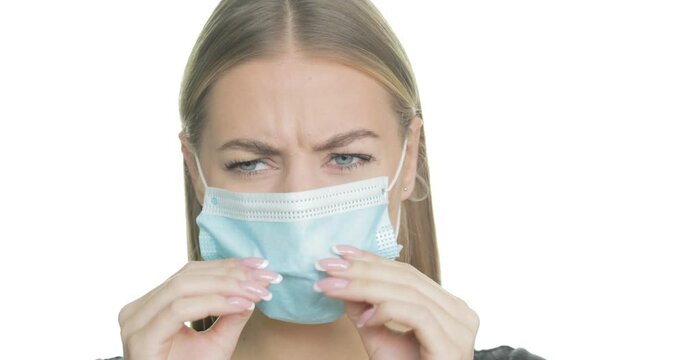 Frustrated Woman Puts On Her Face Mask And Then Rips It Off In Anger.