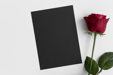 Black invitation card mockup with a red rose. 5x7 ratio, similar to A6, A5.