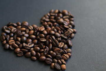 roasted coffee beans heart on black background