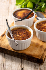 Homemade creme brulee in bowl on wooden table