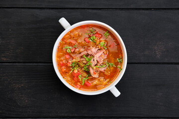 Top view of thick, spicy and sour soup with beef