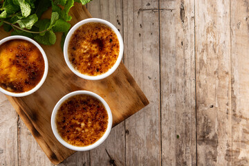 Homemade creme brulee in bowl on wooden table.Top view. Copy space