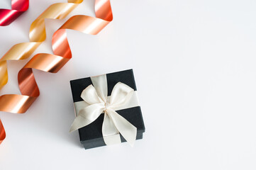 a gift on a white background. Open gift box with red ribbon on white background. Gift box with white ribbon on white marble background. Gifts, celebration, valentines theme