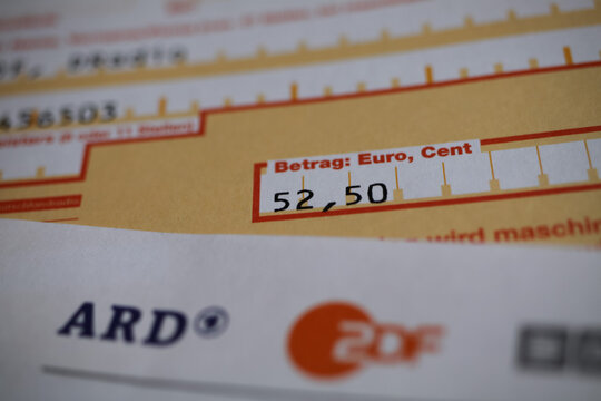 Viersen, Germany - June 8. 2020: Close up of bank transfer form from german radio and tv broadcast service about euro 52,50 (GEZ, ARD and ZDF Beitragsservice - focus on center)