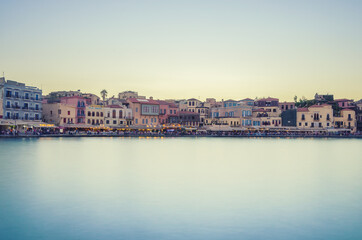 Fototapeta na wymiar Picturesque view of old harbour of Chania during sunset with silky sea. Crete, Greece.