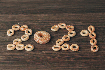 From Many bagels and gingerbread folded 2021 on a Brown Background