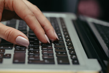 woman using laptop, searching the internet, viewing information, having a job at home