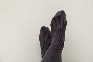 woman in gray socks on a light beige background