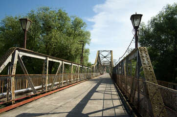 Walking bridge across river. Old rusty steel bridge. Galich, Ukraine