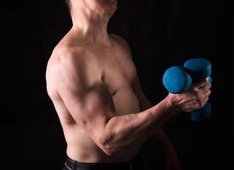 Fototapeta na wymiar Matured man with naked muscular torso making exercises
