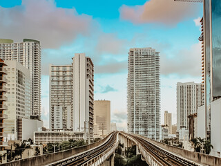 Naklejka premium View of financial district,skyscrapers and metrorail in Miami, Florida, United States.Modern Public transport.Fast way getting around Downtown Miami.Explore popular attractions.Urban city scene.