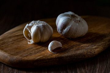 Garlic Cloves and Bulb on vintage wooden Board