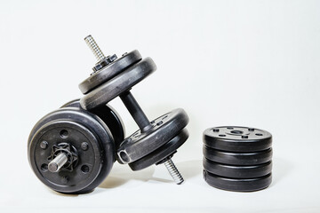 Weights on a white background. The concept of sports, exercises in the gym.