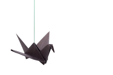 A black paper origami bird hanging with string