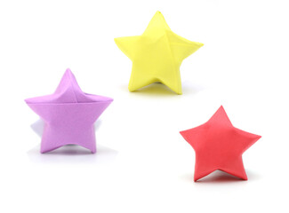 three lucky paper stars on white