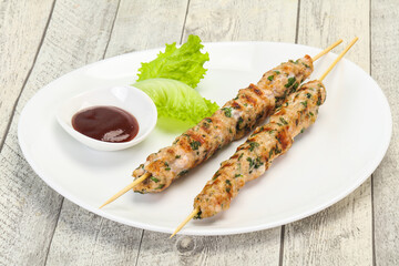 Minced pork skewer kebab with sauce