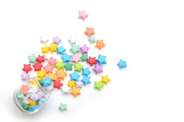 Colorful origami stars with cup on wooden table. Top view