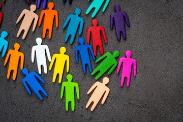 Equality and diversity concept. Multi-colored wooden figurines on a blackboard.