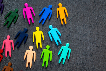 Equality and diversity concept. Multi-colored wooden figurines on a blackboard.