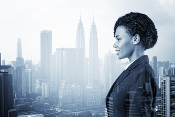 Successful smiling black African American business woman in suit. Kuala Lumpur cityscape. The concept of woman in business. KL skyscrapers. Double exposure.