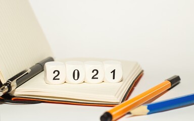 2021 new year written with cubes, change, finger