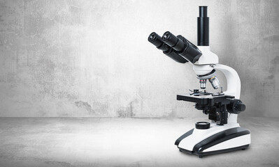Biological microscope on a gray stone background. Scientific concept, biology. Conducting biological research, checking tissues.