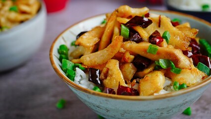 Spicy Fish with dry red chillies and schezwan peppercorn served with Jasmine rice, selective focus