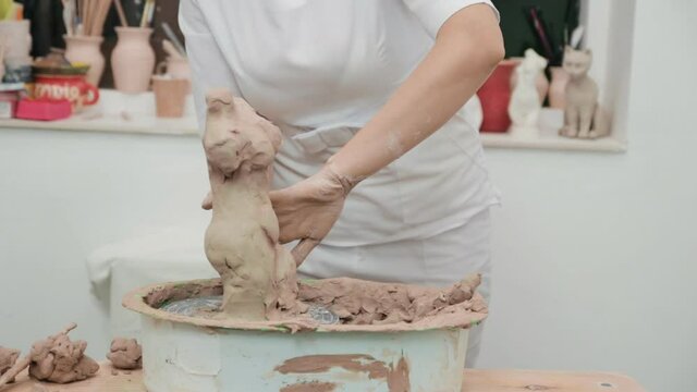 Woman working with clay with her hands. Pottery workshop. master class and training.