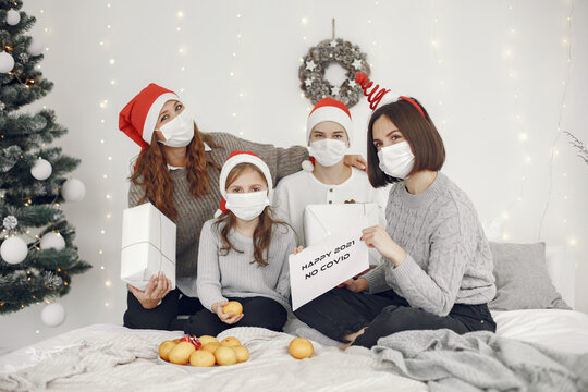 People reparing for Christmas. Two mothers playing with their children. Coronavirus thime. Isolation.