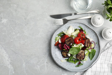 Delicious salad with roasted eggplant, basil and cheese served on grey marble table, flat lay. Space for text