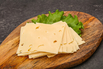 Sliced yellow cheese over board