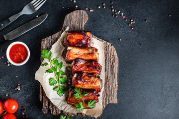 grilled ribs BBQ pork in spices and tomato sauce piece of meat second course snack ready to eat on the table healthy meal snack ingredient top view copy space for text food background rustic