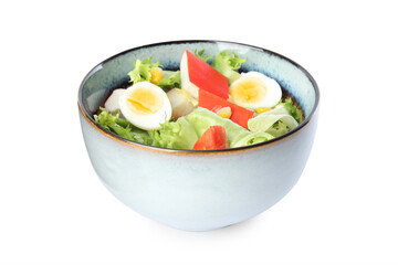 Delicious salad with crab sticks and eggs in ceramic bowl on white background