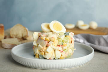 Delicious salad with crab sticks and eggs on table, closeup