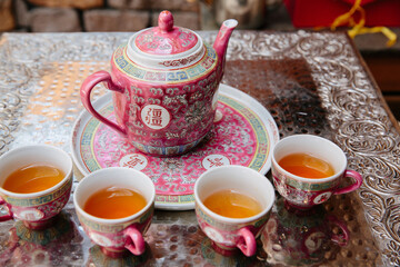 beautiful traditional chinese teapot with filled tea cups