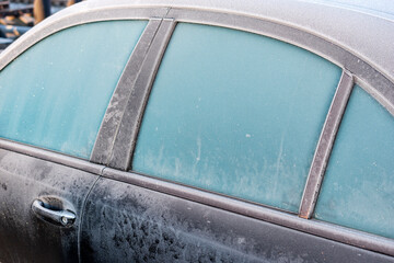 Obraz premium Side view of frozen car in winter morning.