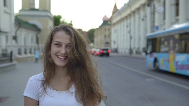 Beautiful girl with a smile on the background of the city