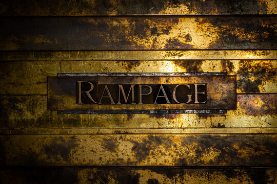 Rampage text formed by real authentic typeset letters on vintage textured grunge bronze background