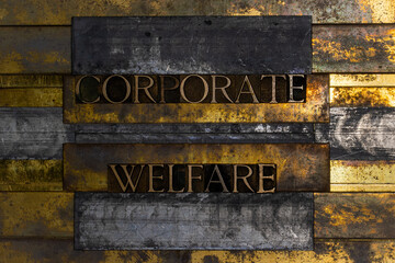 Corporate Welfare text formed by real authentic typeset letters on vintage textured grunge bronze background