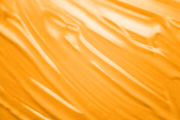 Abstract texture. Liquid gel cosmetics with little bubbles. Yellow background. Face cream. Close-up. Cosmetics product.