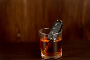 Whiskey with car keys and handcuffs. Concept for drinking and driving.