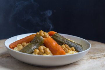 couscous on wooden table and black background